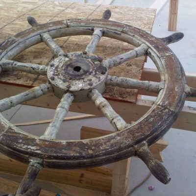 The ship's wheel in the process of being restored.