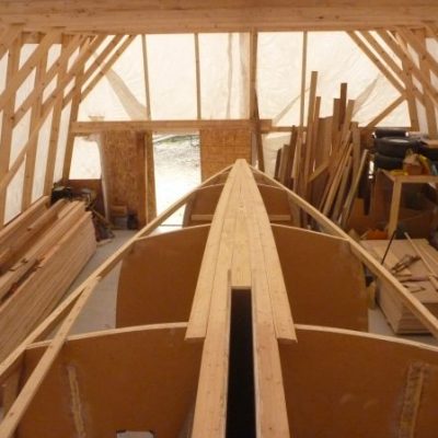 Starter planks are fitted in place forward to the bow and around the centerboard trunk