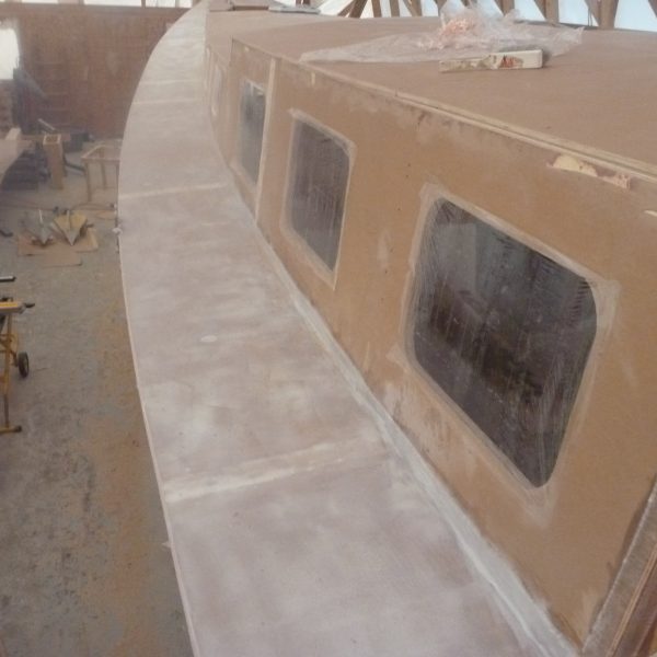 The cabin sides have their port windows are cut out and covered in plastic.