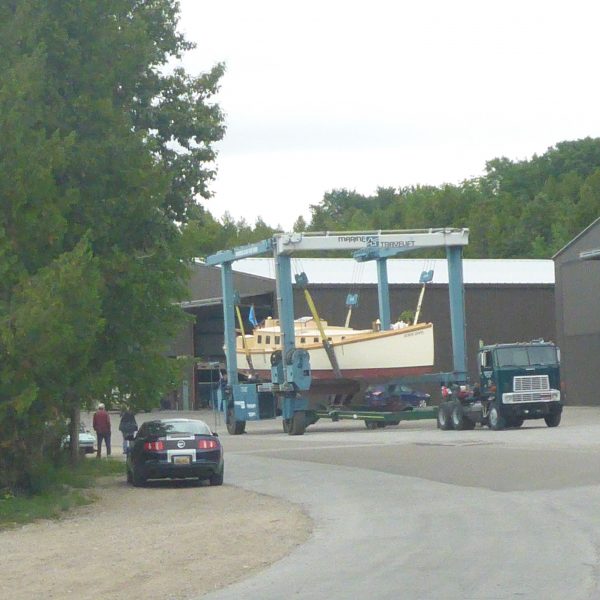 Yacht Haven’s travel lift carefully carries Huron Jewel to the water.